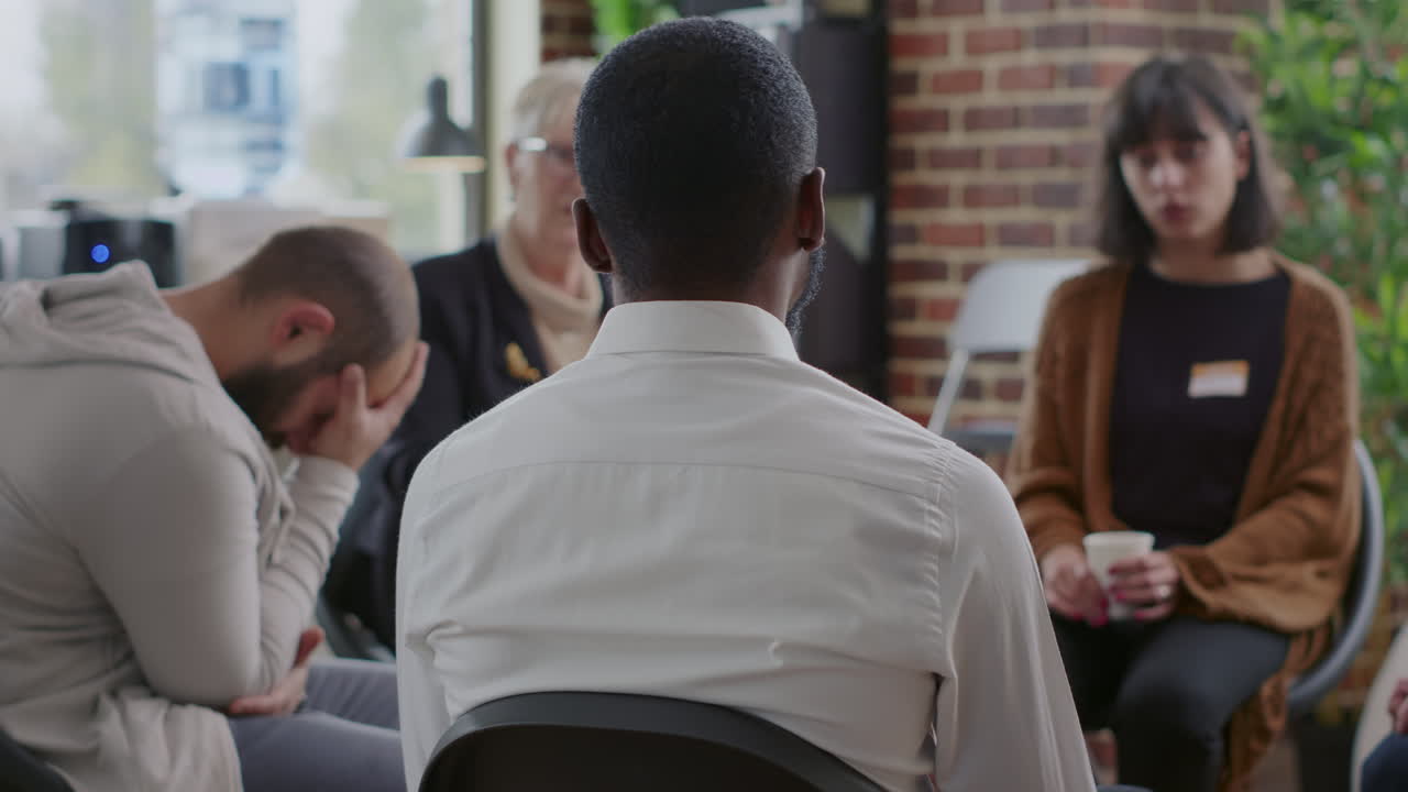 Close up of african american man discussing alcohol addiction at aa therapy session