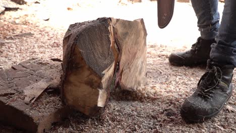 A carpenter cutting some wood with a chainsaw