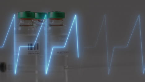 animation of cardiograph over vials on white background