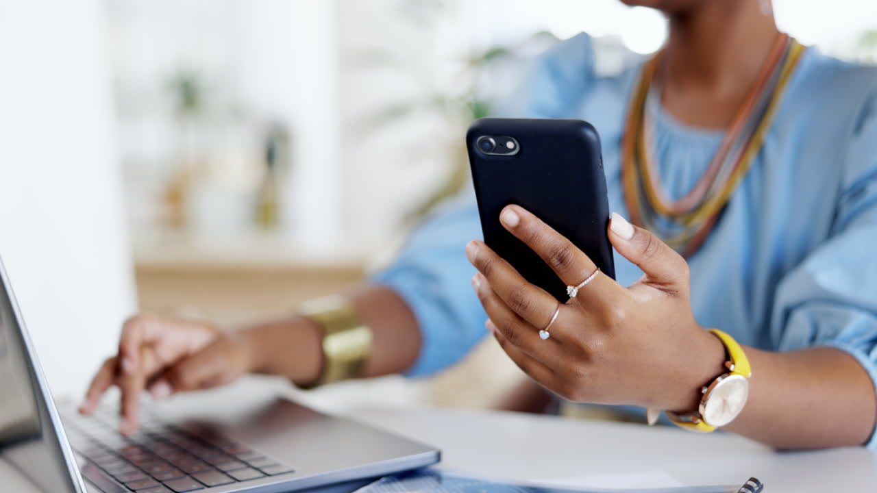 Phone, laptop and hands typing in office
