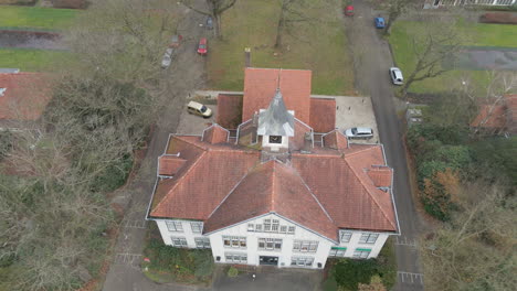 high jib up of old manor with clocktower