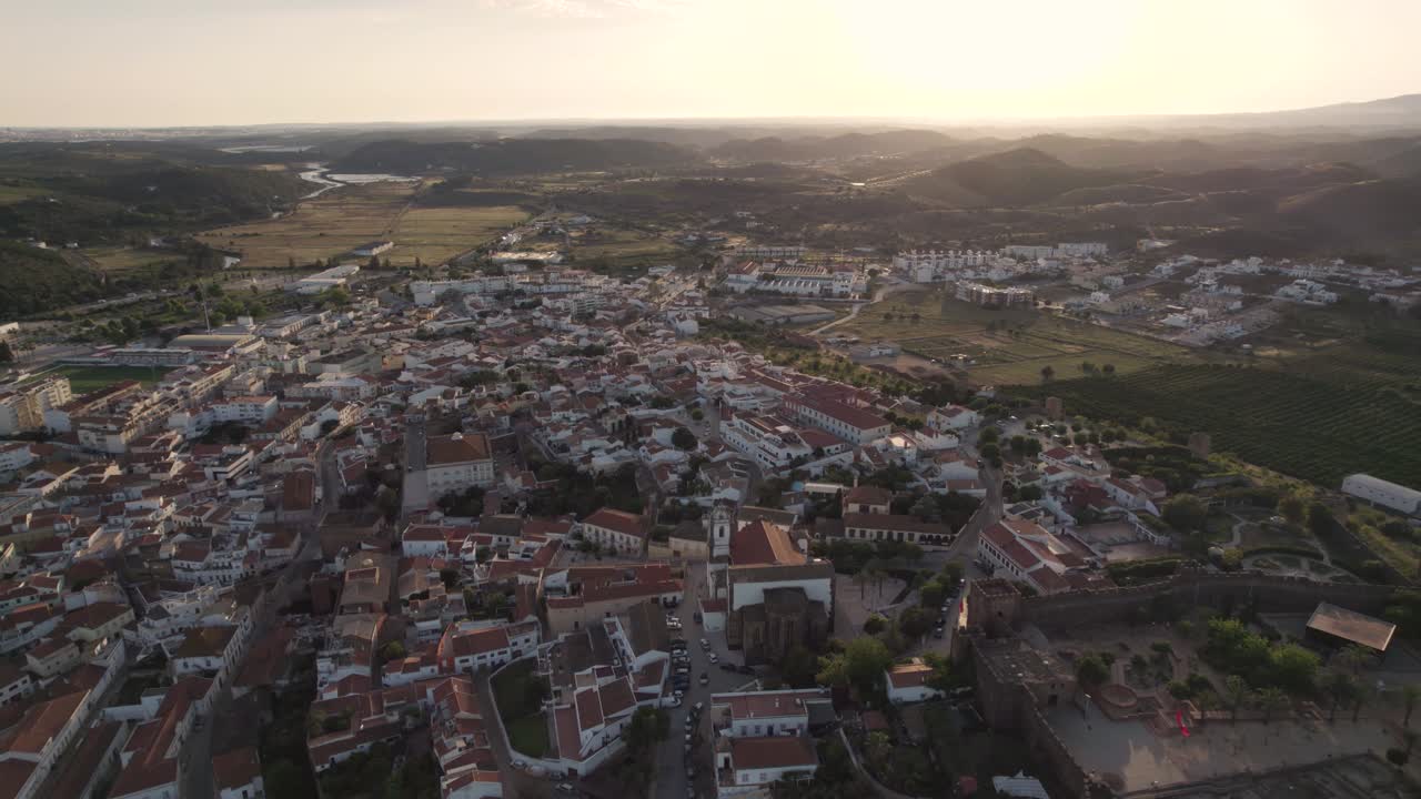 Castle and fortified walled medieval city of Silves, Algarve at sunset. Aerial view