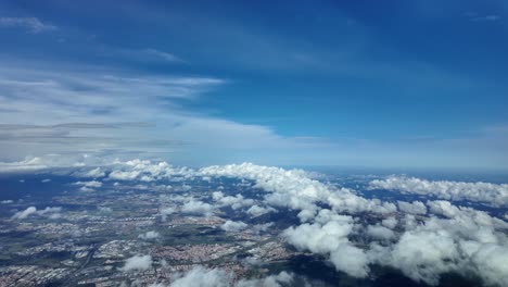 Aerial-view-of-Barcelona-City-arriving-to-the-airport-with-some-clouds-over-the-city