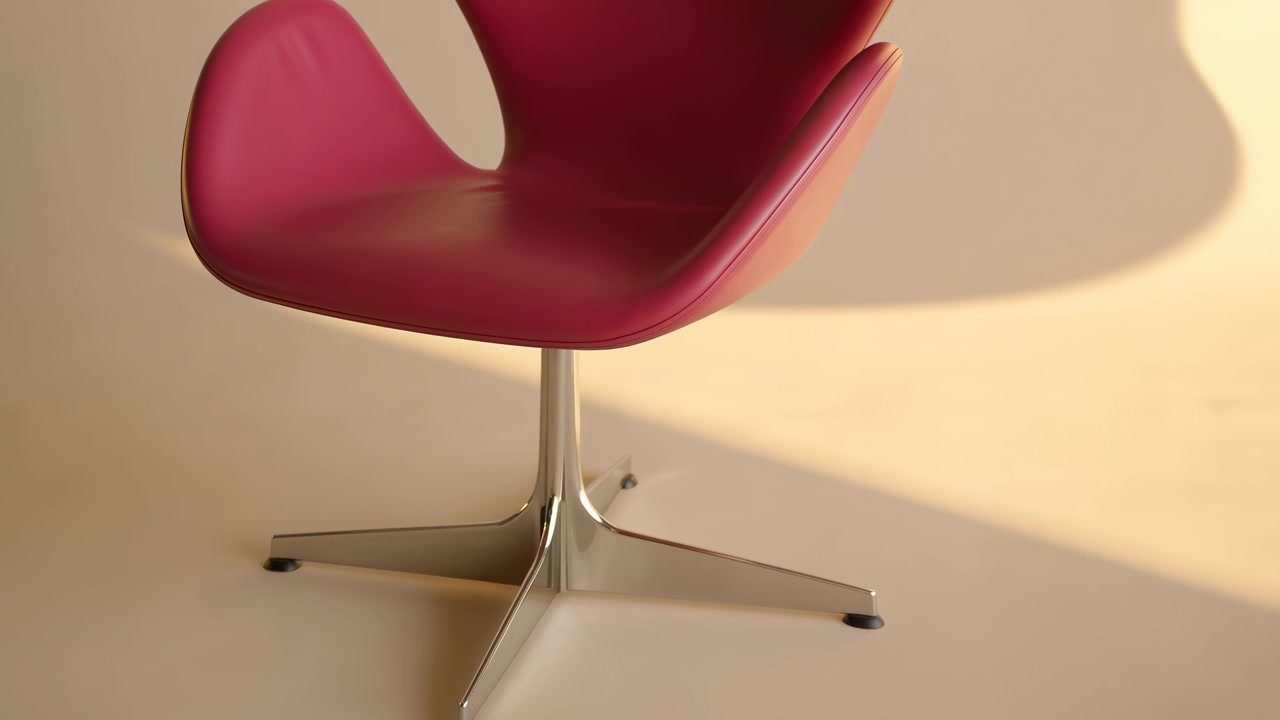Een close-up van een roze stoel geplaatst tegen een witte muur in een neutrale binnenomgeving, vastgelegd vanuit een licht verhoogde hoek. De scène is schoon en minimalistisch, interieur.