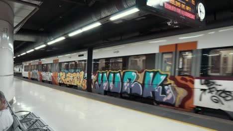 tren del metro en la estación con graffiti