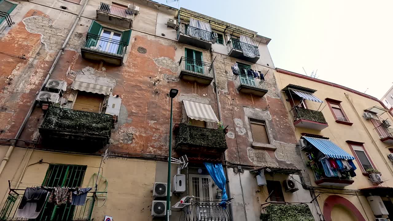 Facciata invecchiata con balconi e bucato steso