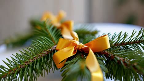 christmas decoration with gold ribbon on fir branches