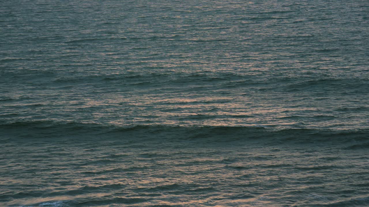 Gentle Sea Waves with Golden Hour Orange Sunlight on Surface. Calming Meditative Nature Ocean Footage. ProRes 4K.