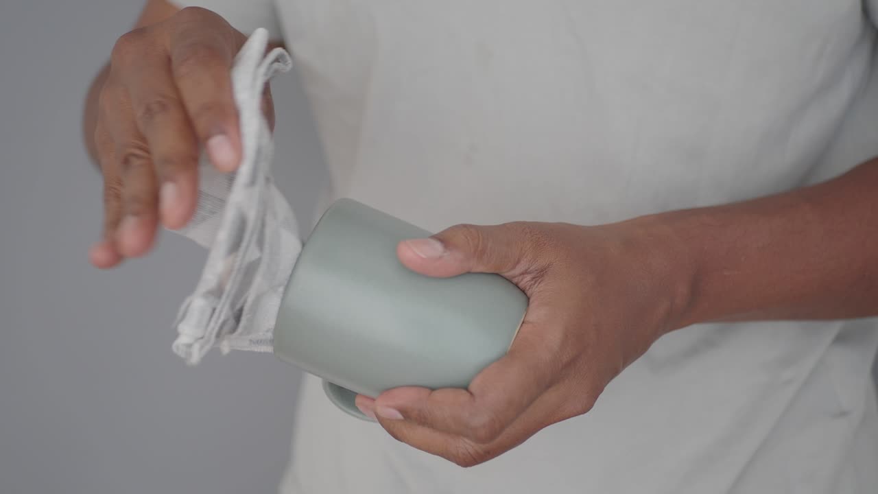 A person cleaning a cup