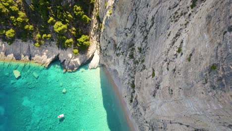 Ascending-and-orbiting-drone-shot-of-the-natural-rock-formations-right-next-to-breathtaking-Oasi-beach-in-Chania-Village-in-Crete,-Greece