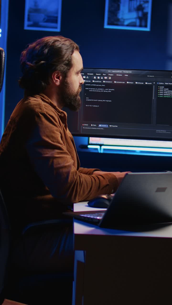 Focused Programmer Working on Code Late at Night in Dark Office