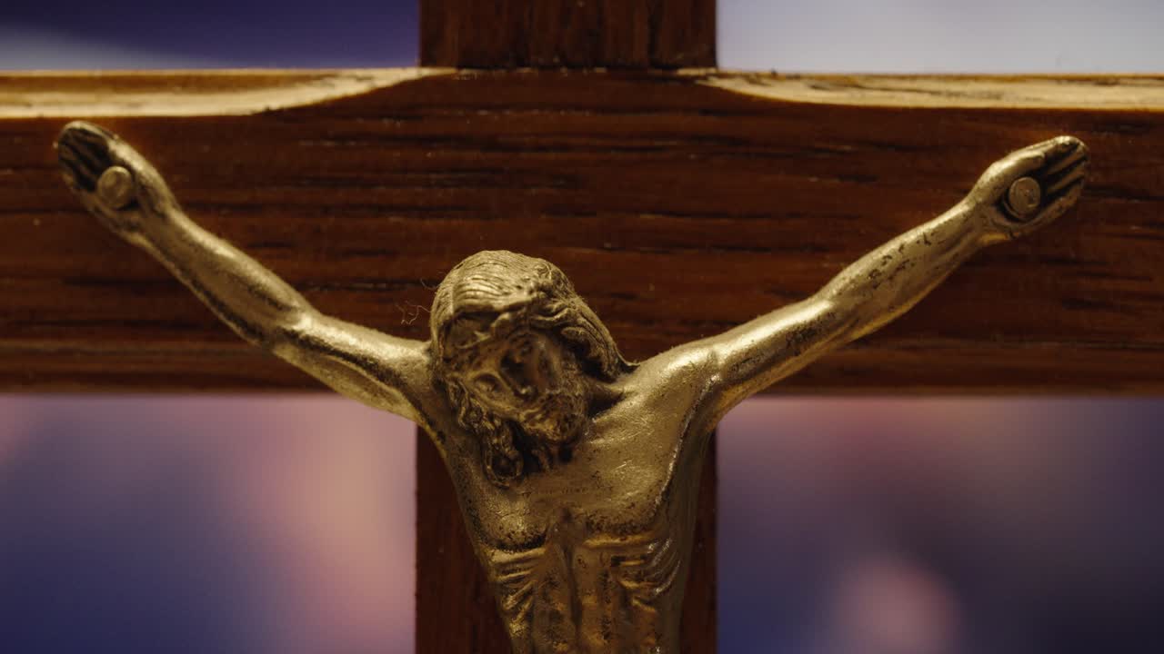 Wooden Crucifix with Jesus Against a Serene Sky close up