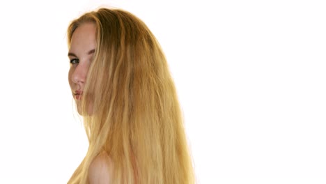 Slow-motion-shot-of-hair-falling-on-the-shoulders-of-a-young-woman-in-the-studio-on-white-background