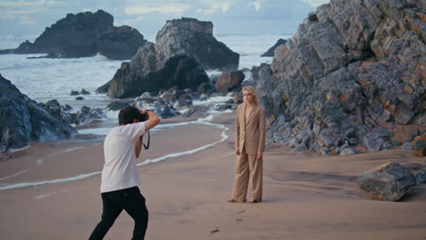 fashion model posing coast on photography session. photographer working ocean