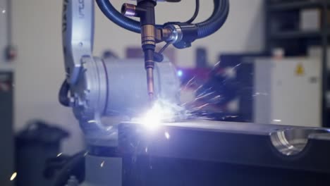 automated welding process: a robotic arm in action creating sparks and joining metal components with precision in an industrial setting