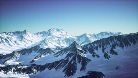 aerial view from airplane of blue snow covered canadian mountain landscape