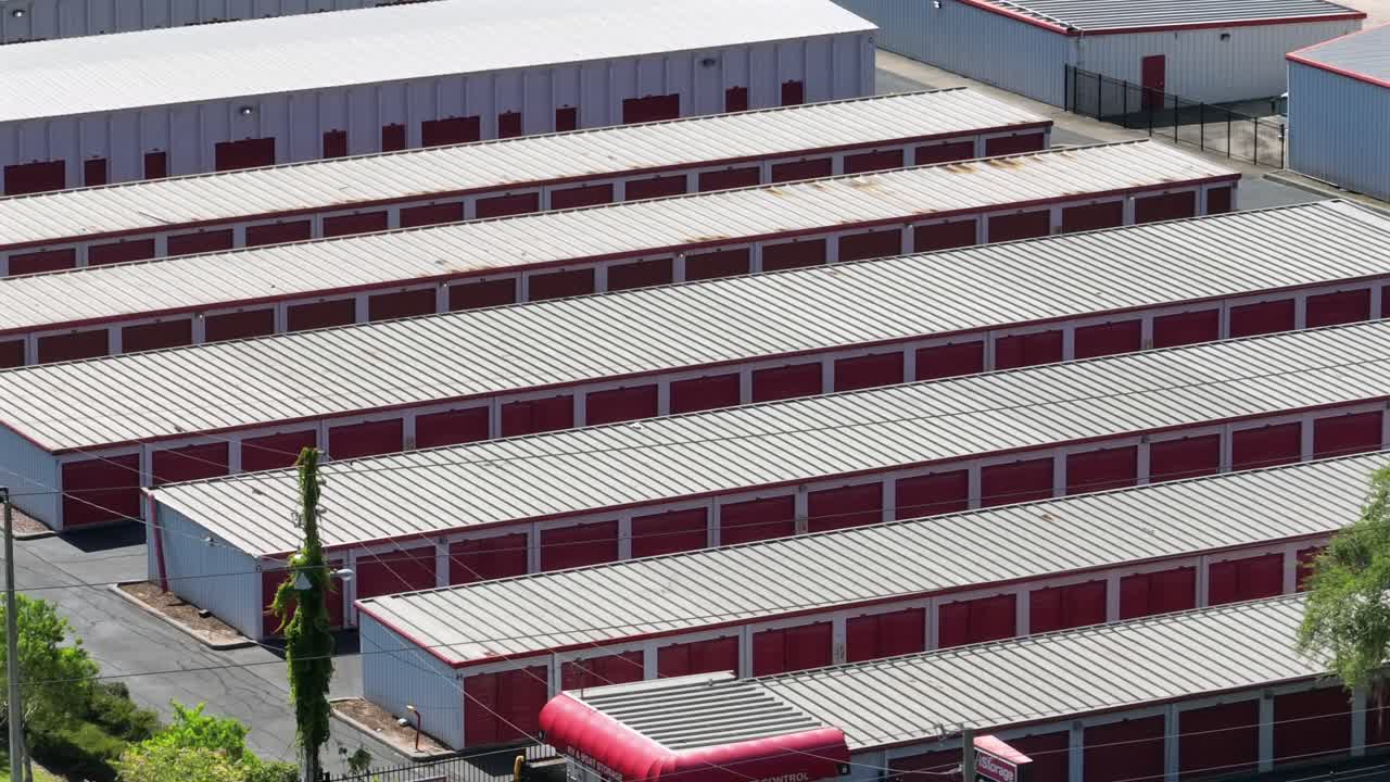 Row of red garages or warehouse temporary storage in american city at sunny day. Aerial top down shot. Industrial district of city. Florida, USA.