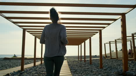 woman running on a beach at sunset