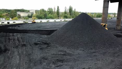 bulldozer moving coal. tractor on production of coal in a traditional manner
