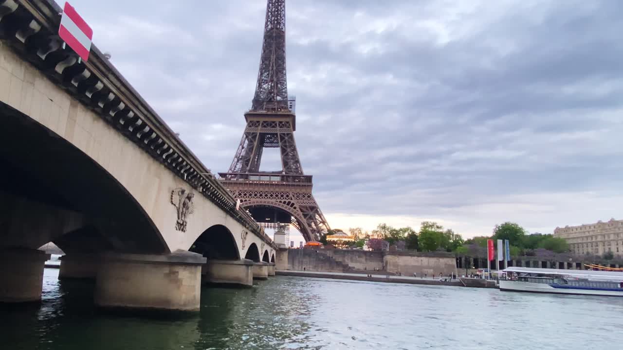 Pont d'Lena Spanning The Seine River With Iconic Eiffel Tower In The Background In Paris, France