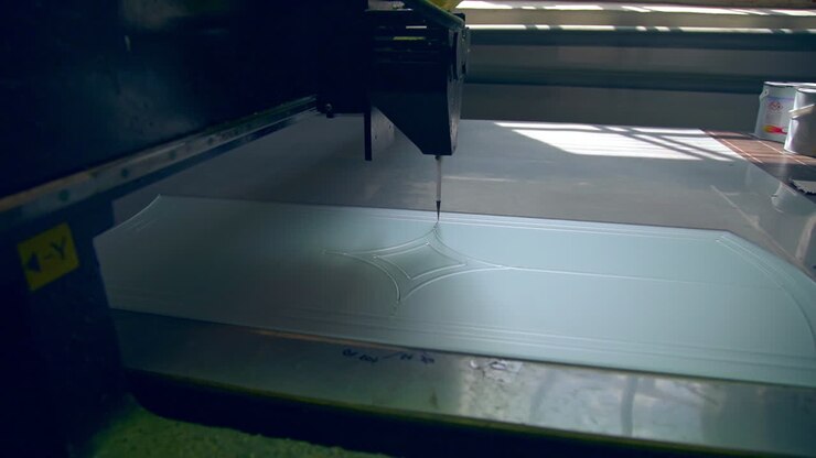 Special equipment for making décor at glass door. Automated machine moves leaving the picture on the glass surface.