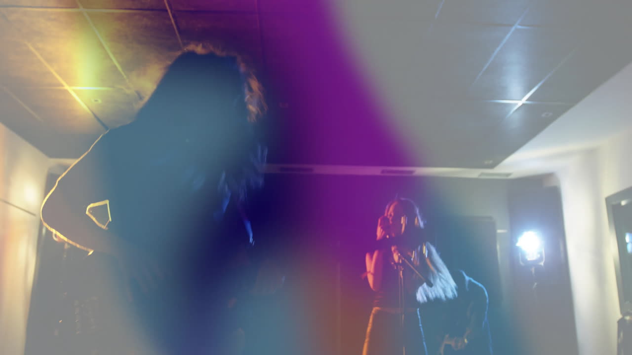 Male bassist playing electric bass under haze while animated waveforms boosting music industry vibe