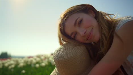 Smiling-girl-sitting-in-park-in-sunny-day.-Closeup-attractive-woman-face-in-park