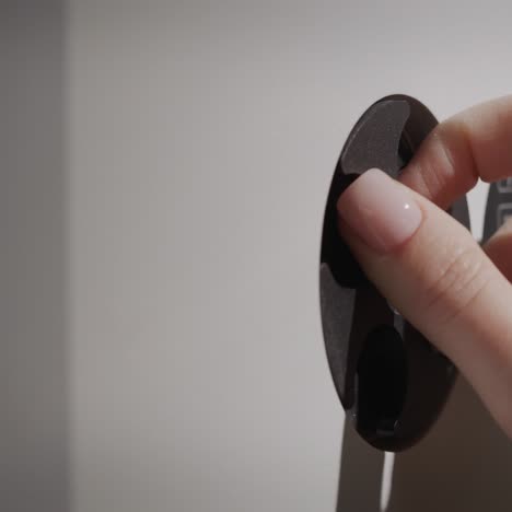 a woman's finger enters the password on the lock of the safe