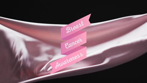 animation of breast cancer awareness text on pink over blowing grey fabric