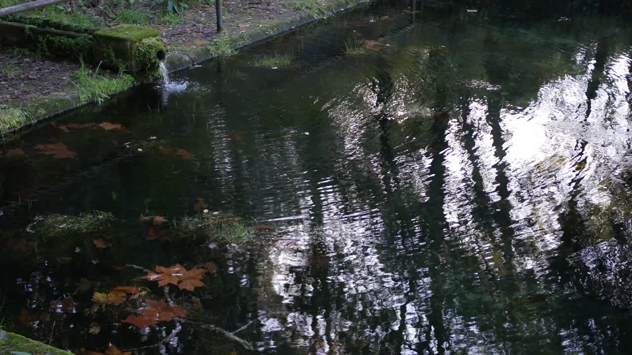 Water falling for a natural stone tube to tank with water.