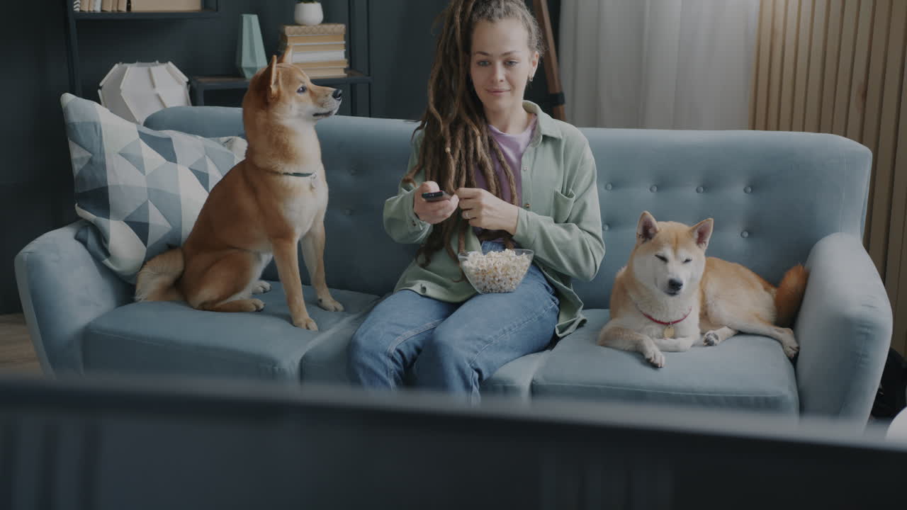 Woman Watching TV with Dogs and Popcorn