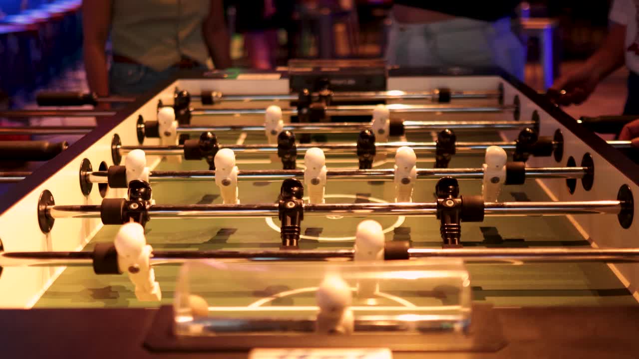 Players engaged in a lively foosball match