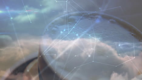 cloudy sky being magnified through circular glass lens, showing network nodes and water droplets
