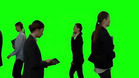 businesspeople walking against green screen