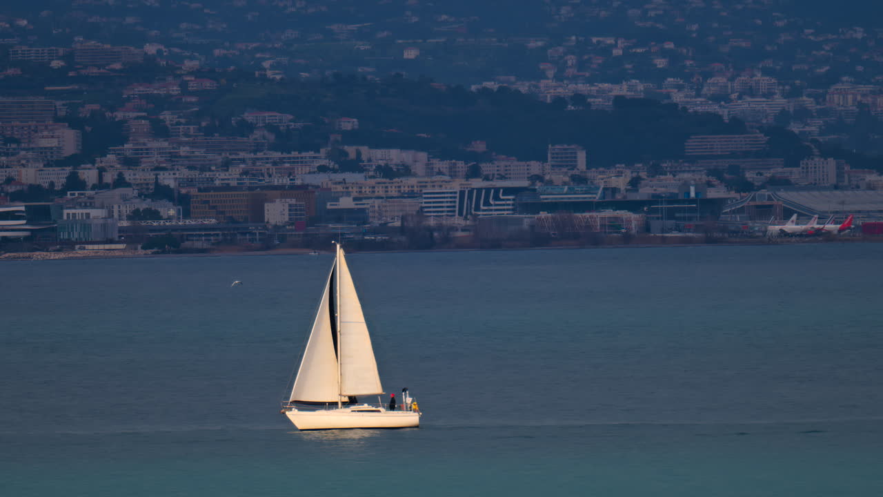 Distant view of a sailing boat moving on the sea