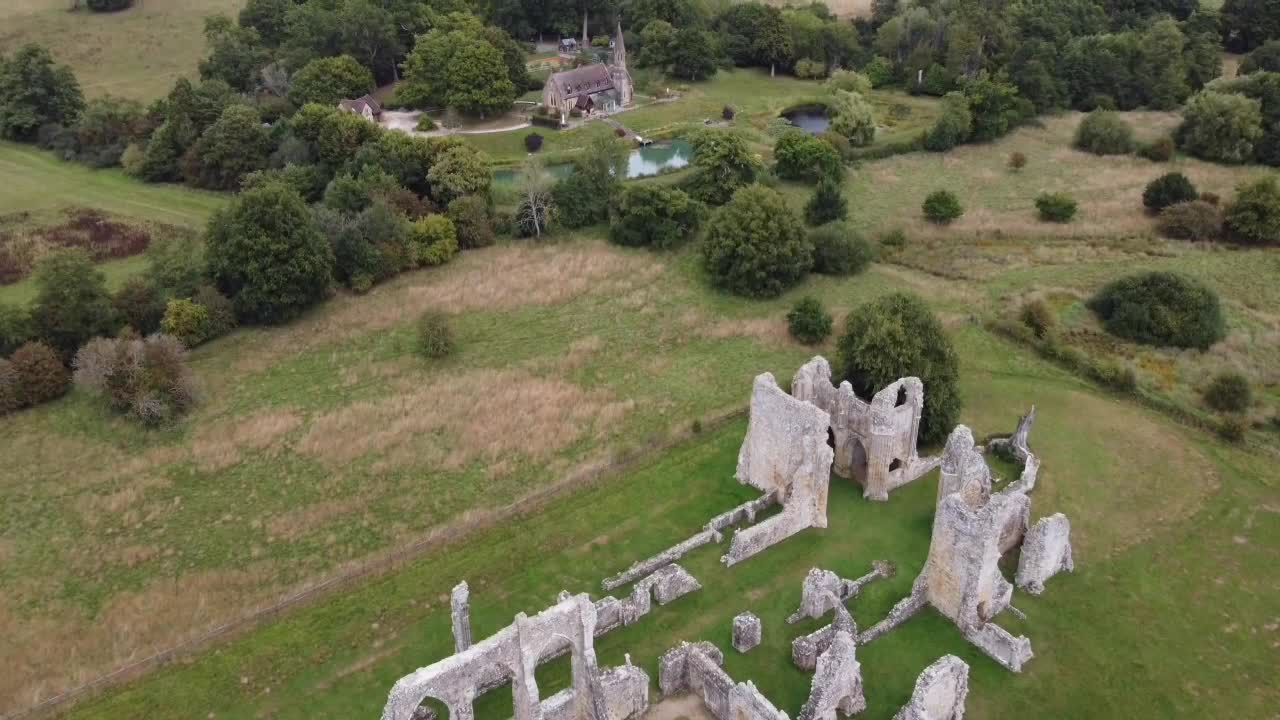 Rising gracefully from the abbey ruins, the camera ascends, revealing a stunning panoramic view of the tranquil English countryside stretching to the horizon