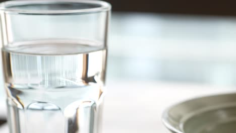 close up of glass of water on table