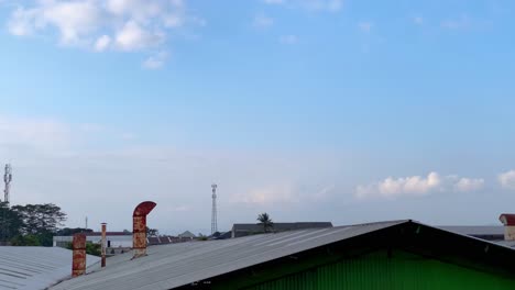 industrial chimneys on the roof of factory building which produces smoke from combustion activity