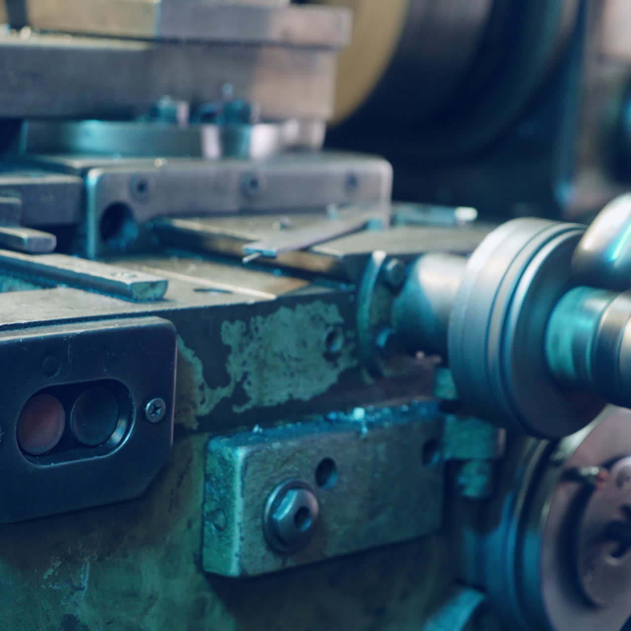 Young mechanic working on a lathe. Metalworking industry.