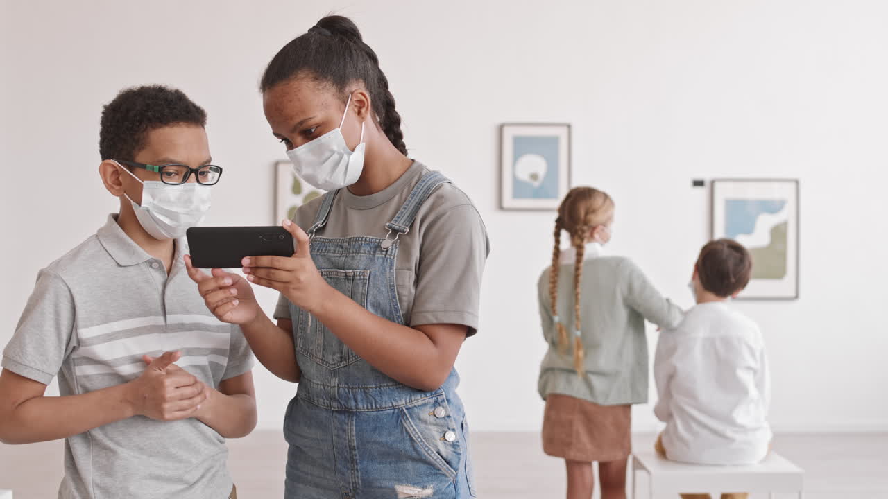African Boy and Girl Using Smartphone in Museum