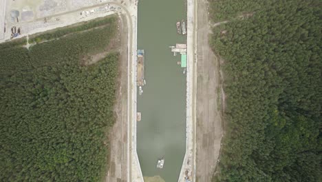 aerial high altitude top-down shot of the huge infrastructure project - the vistula spit canal, shipping channel for container ships