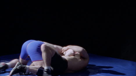 two wrestlers compete on the mat