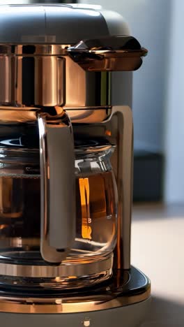 modern coffee maker brewing coffee in a bright kitchen in the morning