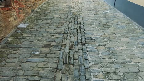 car driving through narrow, historic italian street