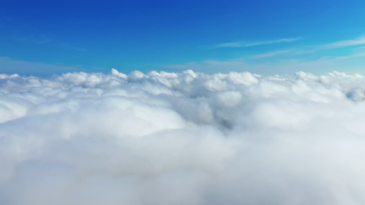 Beautiful white clouds in the air. Panoramic view of blue sky with soft clouds background. Amazing cloudscape. Aerial view.