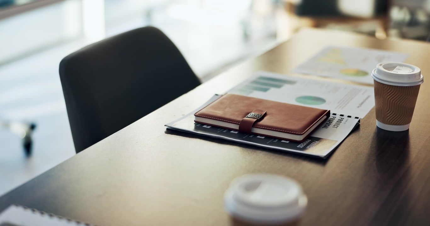 Empty Office Desk with Notebook and Coffee Cup