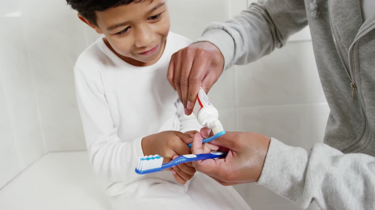Father and son brushing teeth in the bathroom