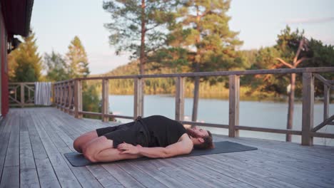 Man Lying In Back With Bended Knees As Part Of Yoga Exercises