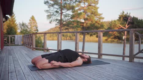 man lying in back with bended knees as part of yoga exercises