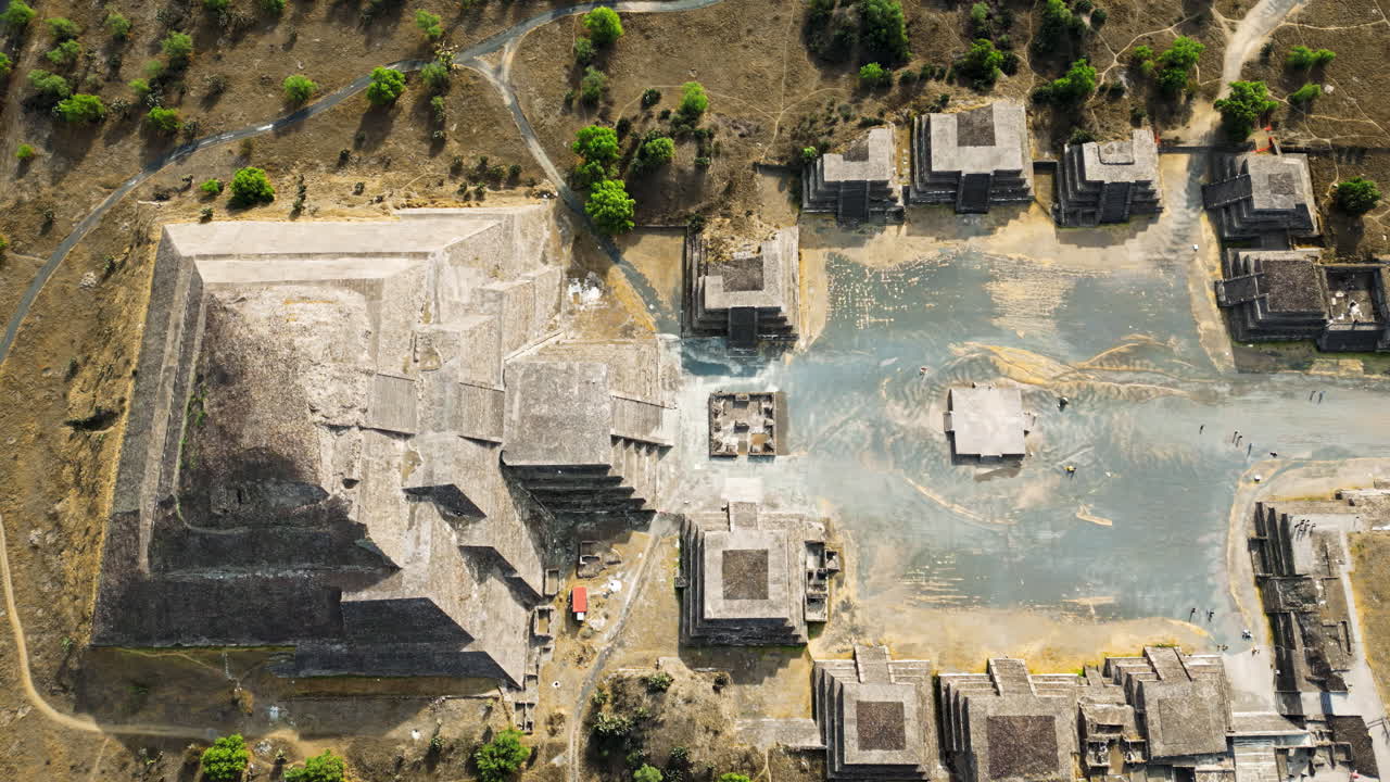 Aerial drone view of the ancient Teotihuacan pyramids with the surrounding Mexican town and mountain landscape